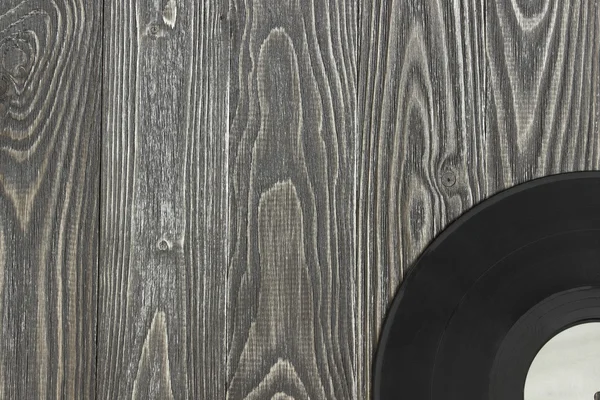 Die musikalische Tonplatte liegt auf einem Holztisch. Hintergrund von oben — Stockfoto