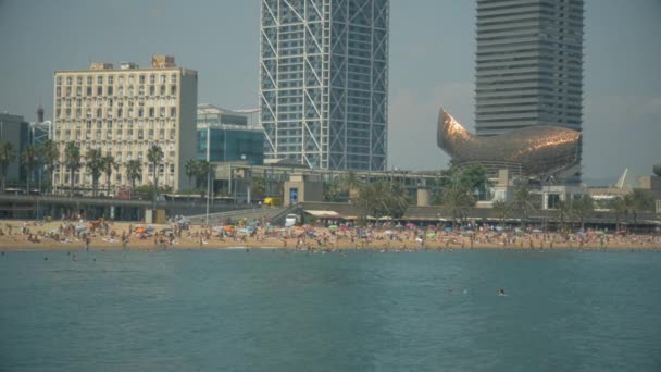 Detail of Barceloneta beach and Barcelona sky line from the sea — Stock Video