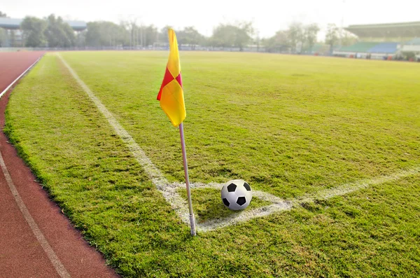 Corner flag with ball on a soccer field — Stock Photo, Image