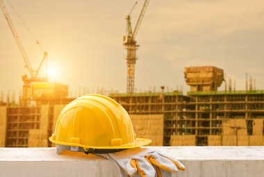 yellow hard hat on construction site clipart