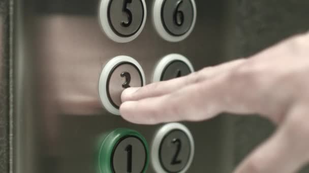 Man presses a button the third floor in an elevator — Stock Video