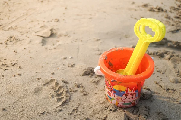 Plastic speelgoed emmer aan het zandstrand — Stockfoto