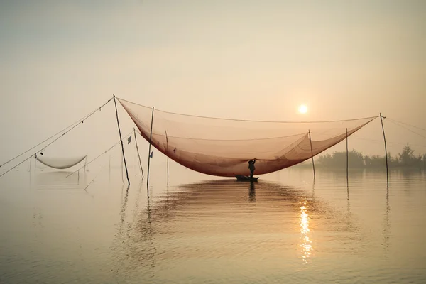 Unidentified fisher man check his nets — Stock Photo, Image