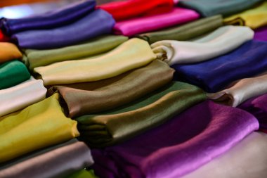 Traditional clothes made from silk are sold in Inle lake, Myanmar clipart