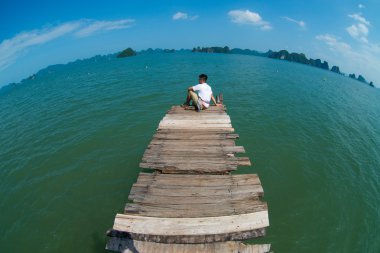 Young man travel in Halong bay clipart