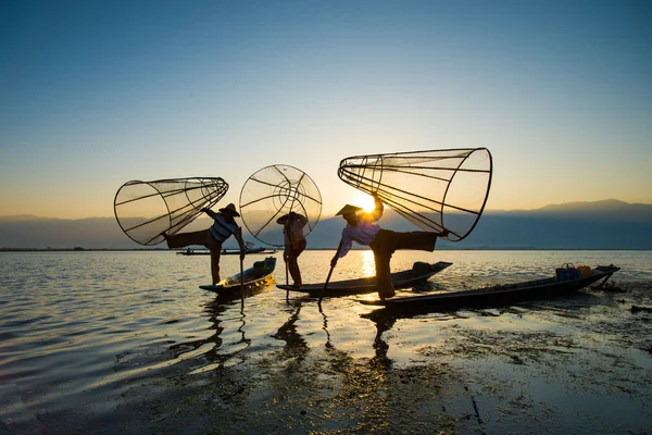 Three fishermen catches fish — Stock Photo, Image