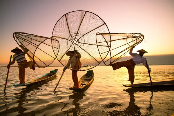 Three fishermen catches fish — Stock Photo, Image