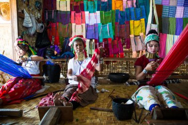 Unidentified Burmese long neck girls weaving