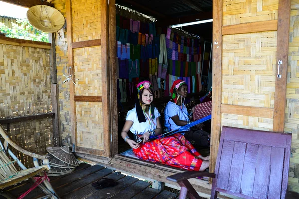 Unidentified Burmese long neck girls weaving