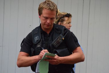 30th may 2015 - Bideford, Devon Police man taking notes after an Incdent took place clipart
