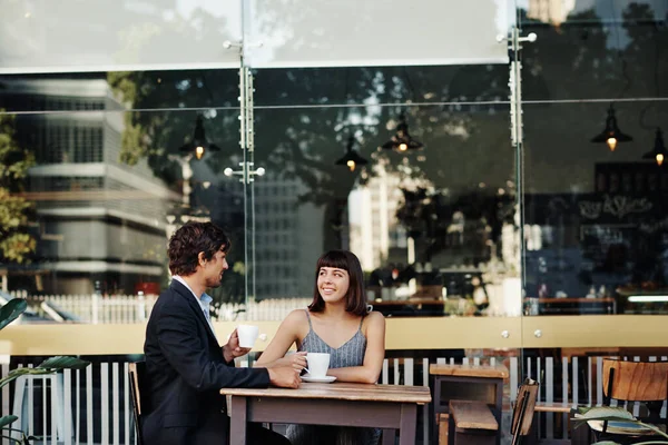 Shot of a young couple on a coffee date at a sidewalk cafe