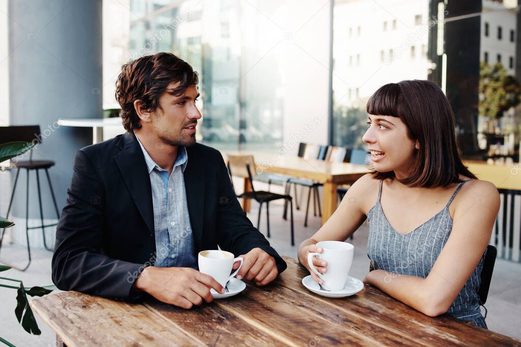 Cropped shot of a happy young couple out on a date at a coffee shop