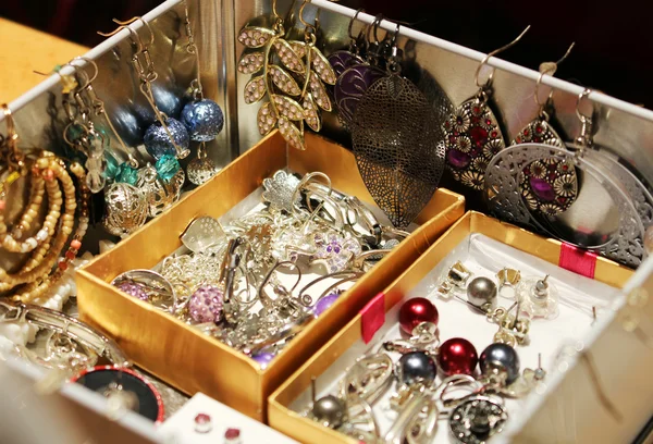 Box full of women's jewelry and earrings Stock Image