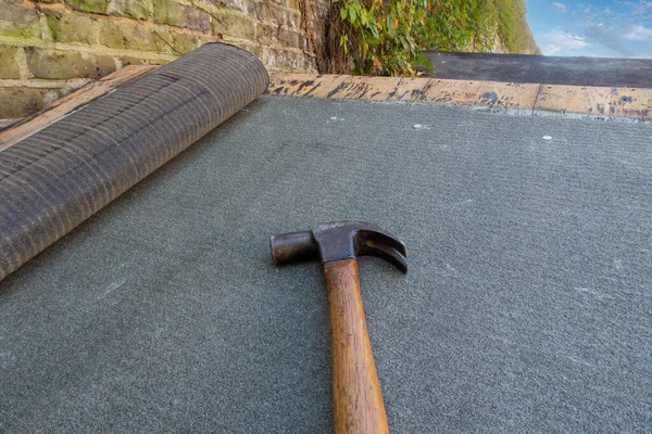 Shed or roof felt being fitted on a shed