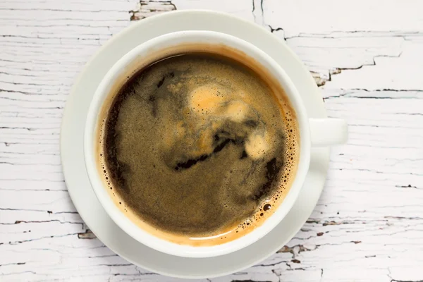 Cup of coffee on the wooden table — Stock Photo, Image