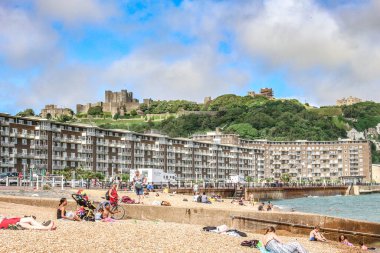 İngiltere 'de güneş ışığı altında yeşillikle kaplı bir tepedeki Dover Kalesi.
