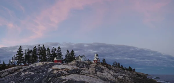 Panorama of Pemaquid Point Light near sunset from the rocks on the coast of Maine