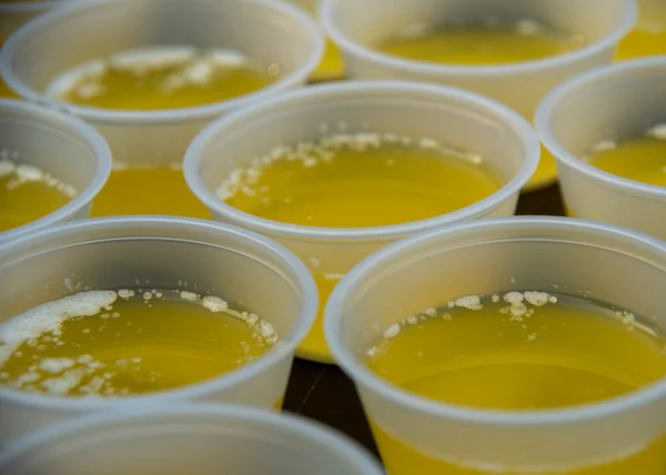 Melted butter ready for the calms and lobster at a Maine clambake