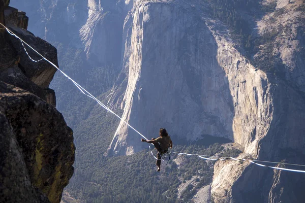 Daredevil wire walker high above a canyon at Yosemite National Park, California
