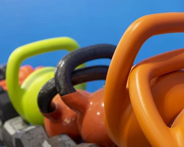 Colorful kettlebells await the fitness trainees at the gym