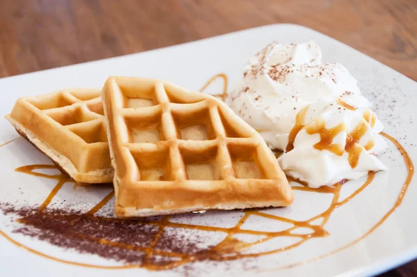 Two waffles on decorated dish