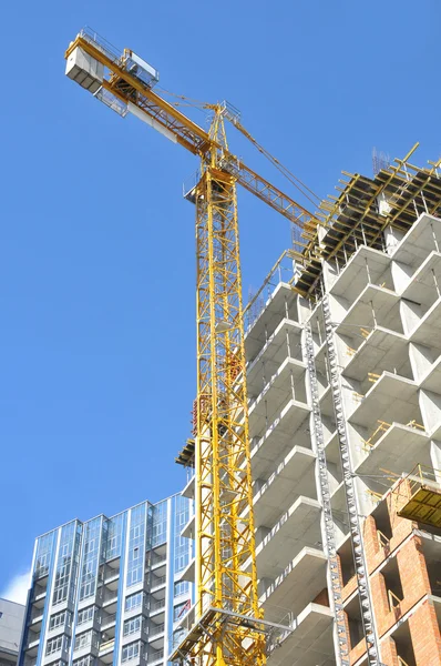 High-rise building under construction with tower crane and scaffolding