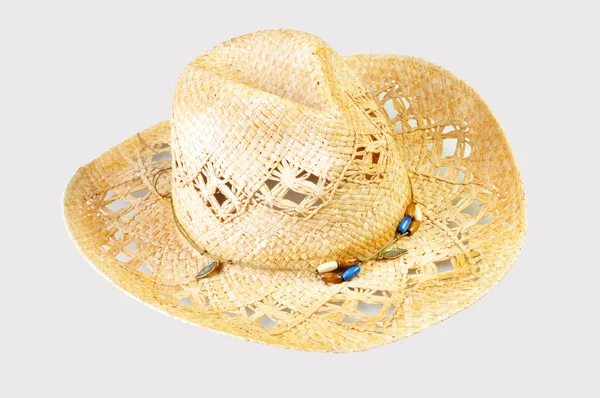 Um chapéu de cowboy de palha em um fundo cinza — Fotografia de Stock