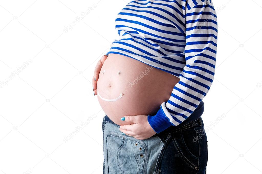 Pregnant woman writing smiley word on her belly. Isolate.