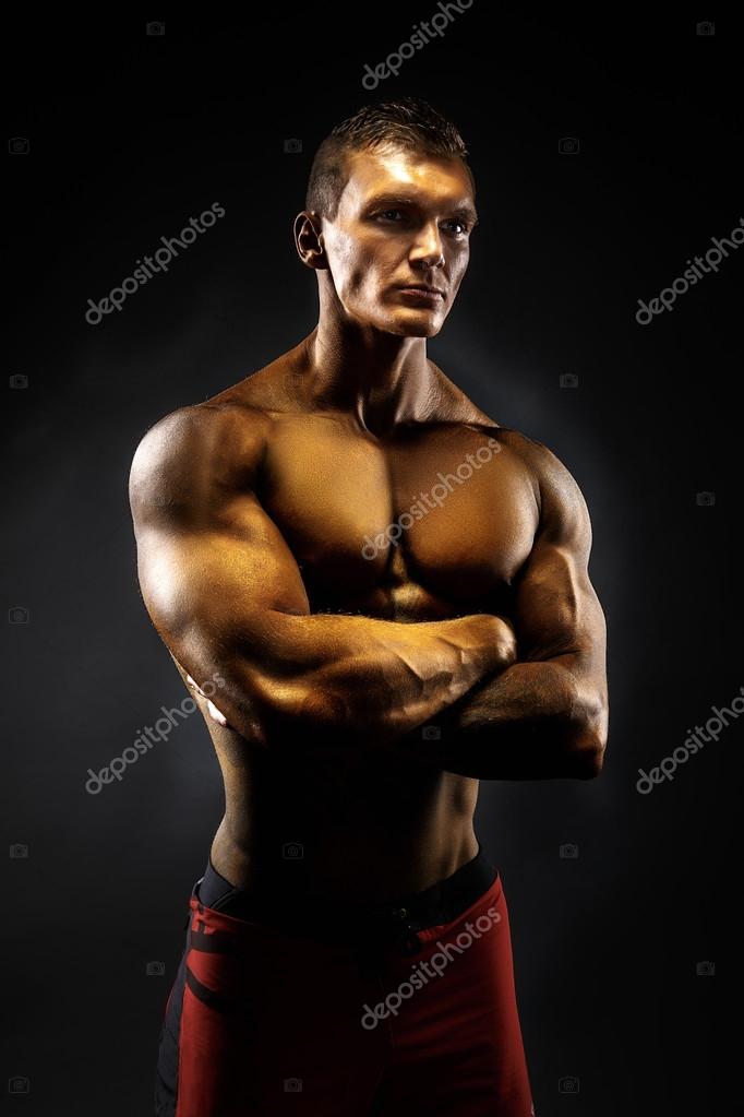 Muscular man crossed his arms. black background — Stock Photo