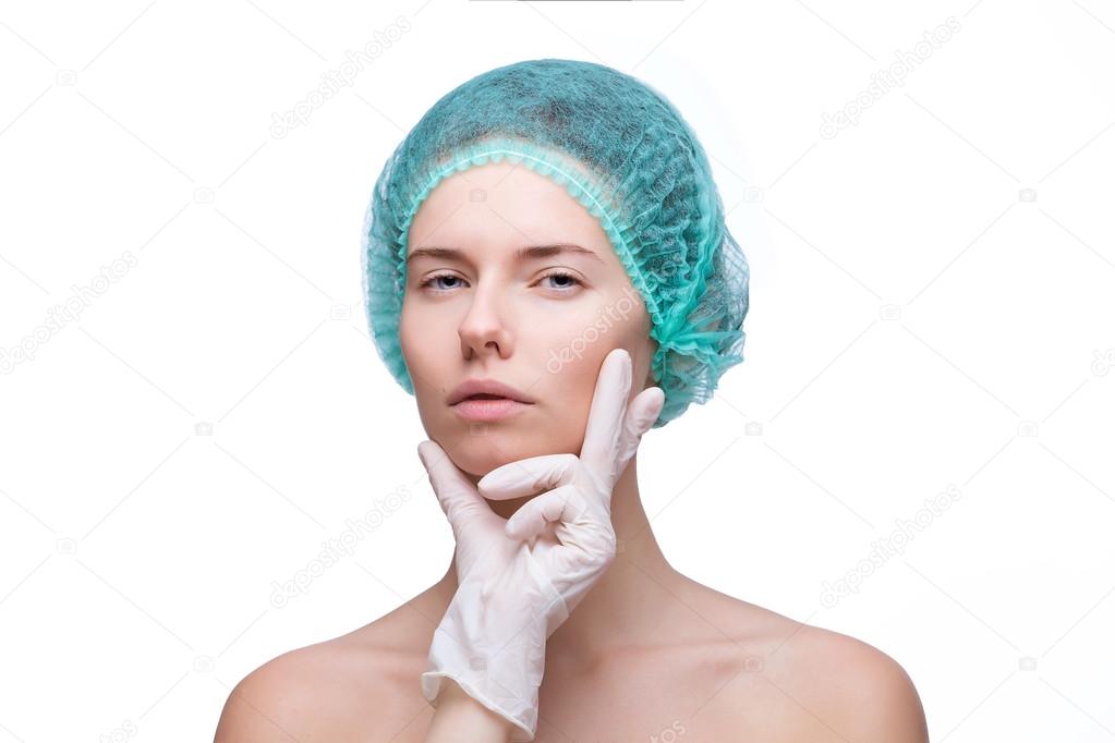 Medical examination face of beautiful woman by hands in glove - close-up portrait isolated on white