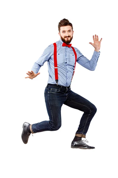 Μοντέρνο τύπος στο μπλε πουκάμισο με κόκκινο παπιγιόν και τιράντες που απομονώνονται σε λευκό. άλμα, συγκίνηση, τρελός, φοβερό. — Φωτογραφία Αρχείου