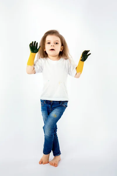 Adorable little girl, modern hair style, white shirt, blue jeans poses,  scream, roar, smile. She has paint smeared on her hands. Isolated. White.  Stock Photo by ©zamuruev 105254252