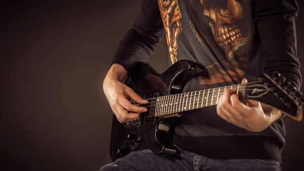 Handsome man playing electro guitar, studio shot — Stock Photo, Image