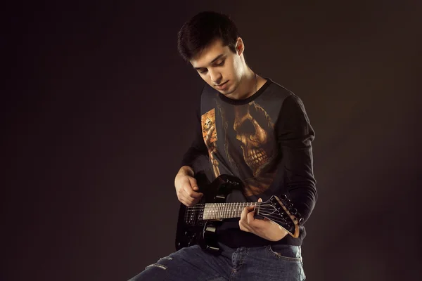 Handsome man playing electro guitar, studio shot — Stock Photo, Image