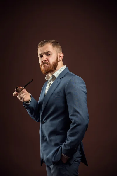 Homem elegante com barba segurando cachimbo de fumar — Fotografia de Stock