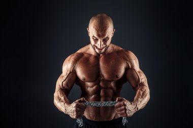 Metal zincir gözyaşı çalışmakla agresif vücut geliştirmeci portresi