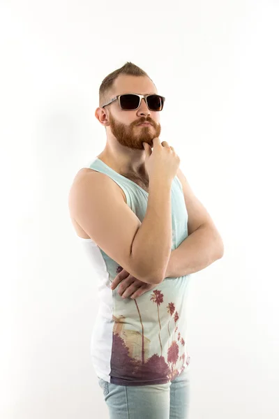 Portrait of young bearded man in sunglasses looking up — Stock Photo, Image
