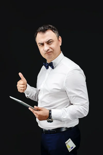 Man with tablet and thumb up. Money sticking out of his pocket — Stock Photo, Image
