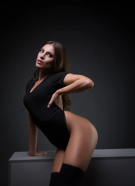 Sexy brunette in black body looking at camera — Stock Photo, Image