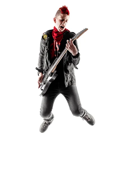 Teen with red mohawk jumping while playing guitar — Stock Photo, Image