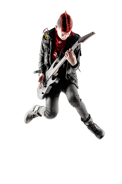 Teen with red mohawk jumping while playing guitar — Stock Photo, Image