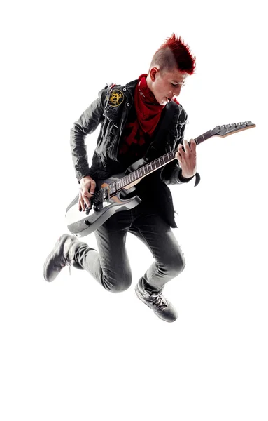 ギターを弾きながらジャンプ赤モヒカンとティーン — ストック写真