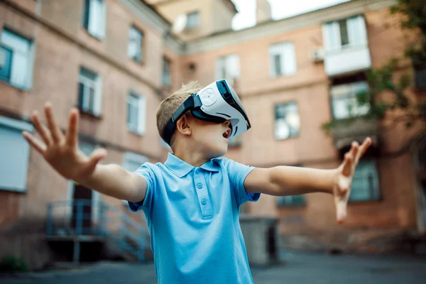 Menino fascinado usando óculos de realidade virtual VR. exterior — Fotografia de Stock