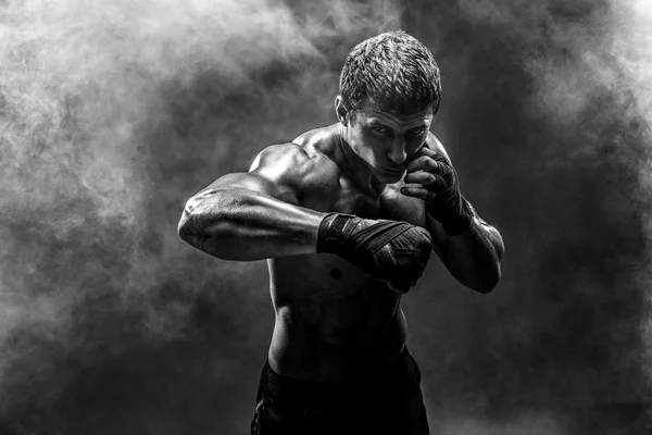 Handsome topless sportsman practicing punches — Stock Photo, Image