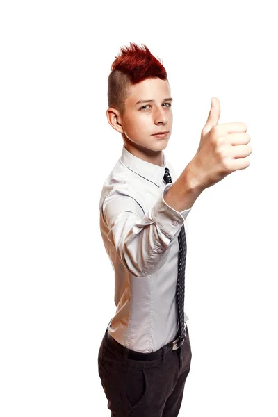 A smiling teenager with red mohawk wearing shirt and tie shows his thumb up isolated on the white background — Stock Photo, Image