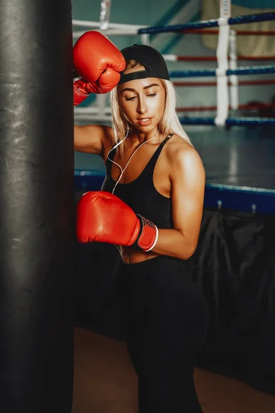 Mooie vrouw met de rode bokshandschoenen. Aantrekkelijke vrouwelijke bokser training — Stockfoto