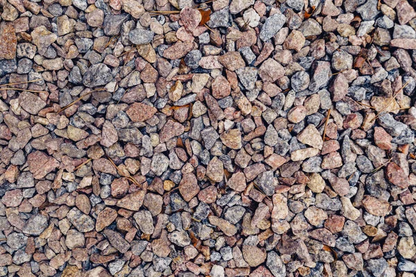 Background of natural grey granite crushed stone, macadam. Macro photo of texture of broken stone or rubble with place for text. Crushed rock. Construction Materials. Textures — Stock Photo, Image