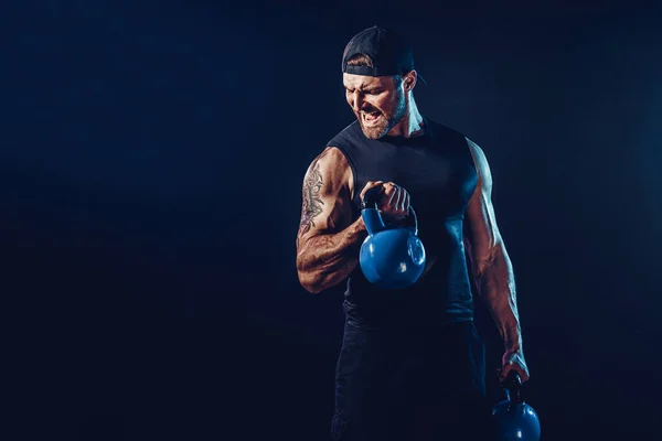 Aggressive bearded muscular bodybuilder doing Exercise for the s