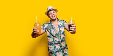 Parlak elbiseli bir adam, sarılı bir içecek.