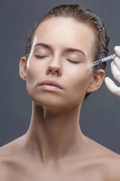 Lekarz kosmetolog wykonuje zabieg odmładzania iniekcji twarzy w celu zaciśnięcia i wygładzenia zmarszczek na skórze twarzy kobiet w salonie kosmetycznym. Kosmetologia pielęgnacji skóry — Zdjęcie stockowe